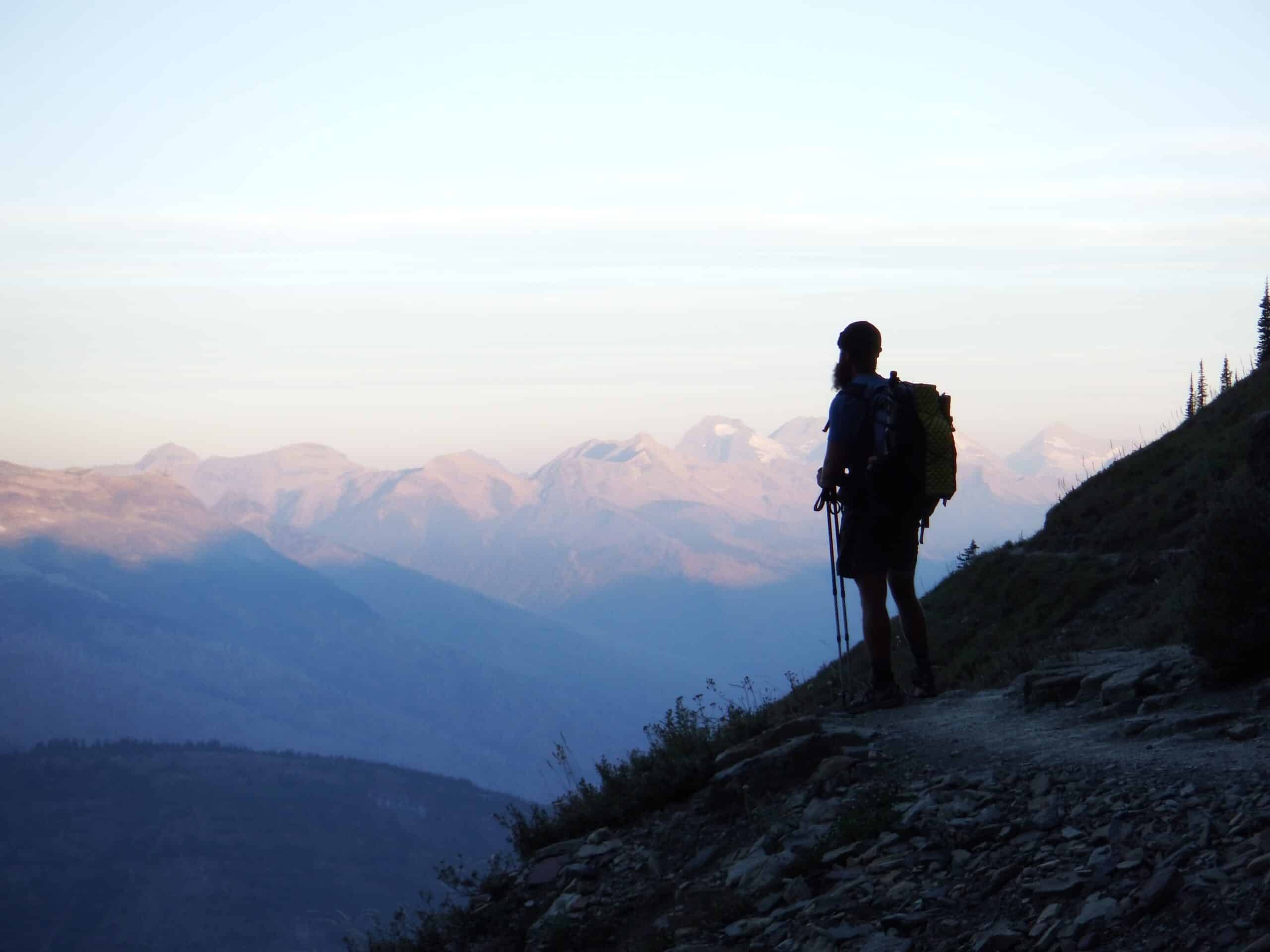 A hiker admires a mountain view in Montana
