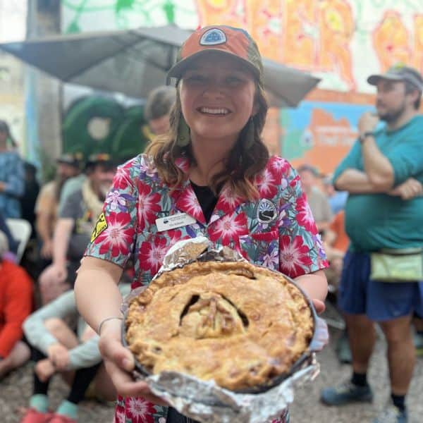 CDTC staffer holding a pie at Trail Days